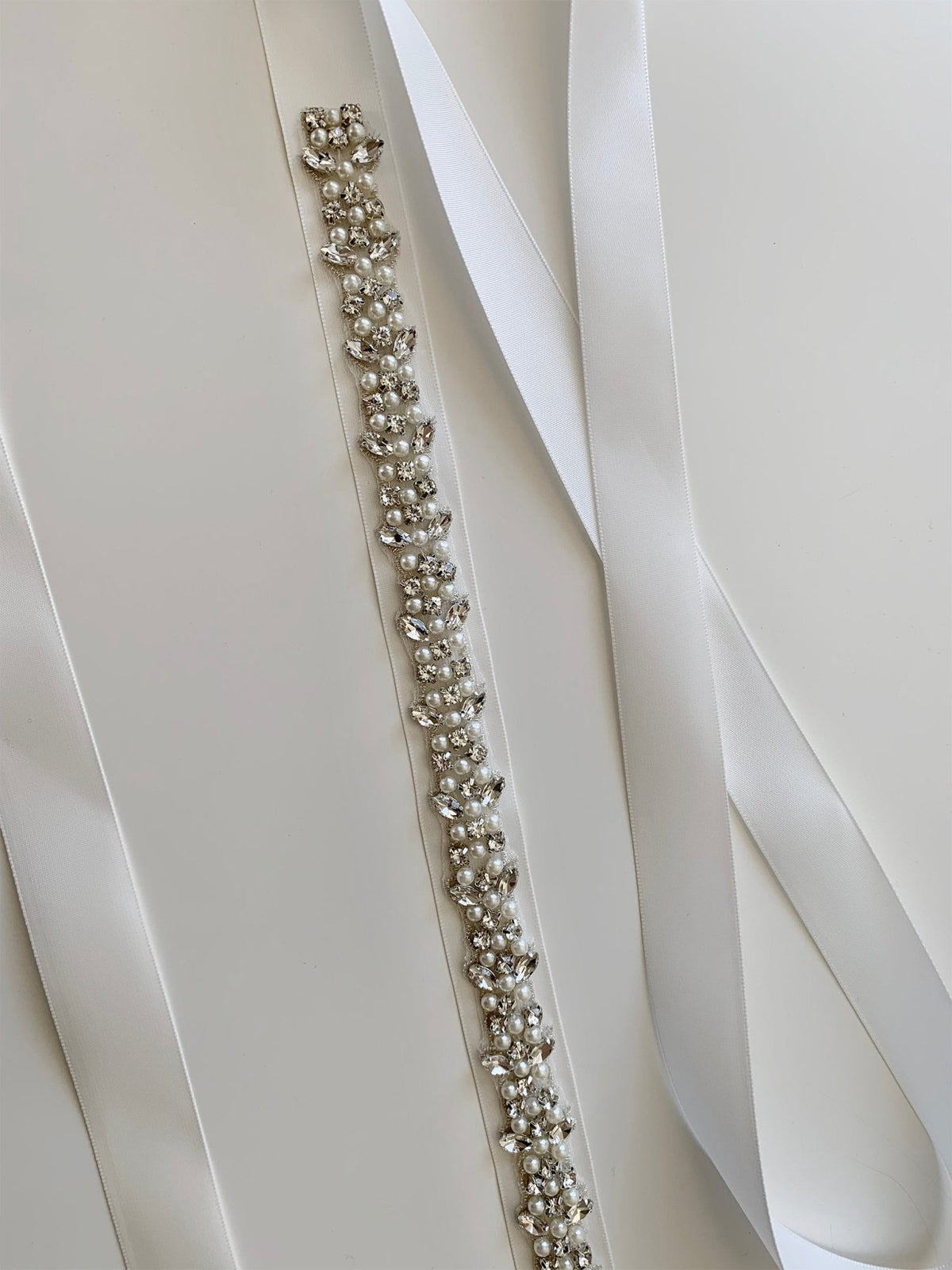 Ivory and white pearl rhinestone flower girl sash belt, close-up, full view, embellishment detail.