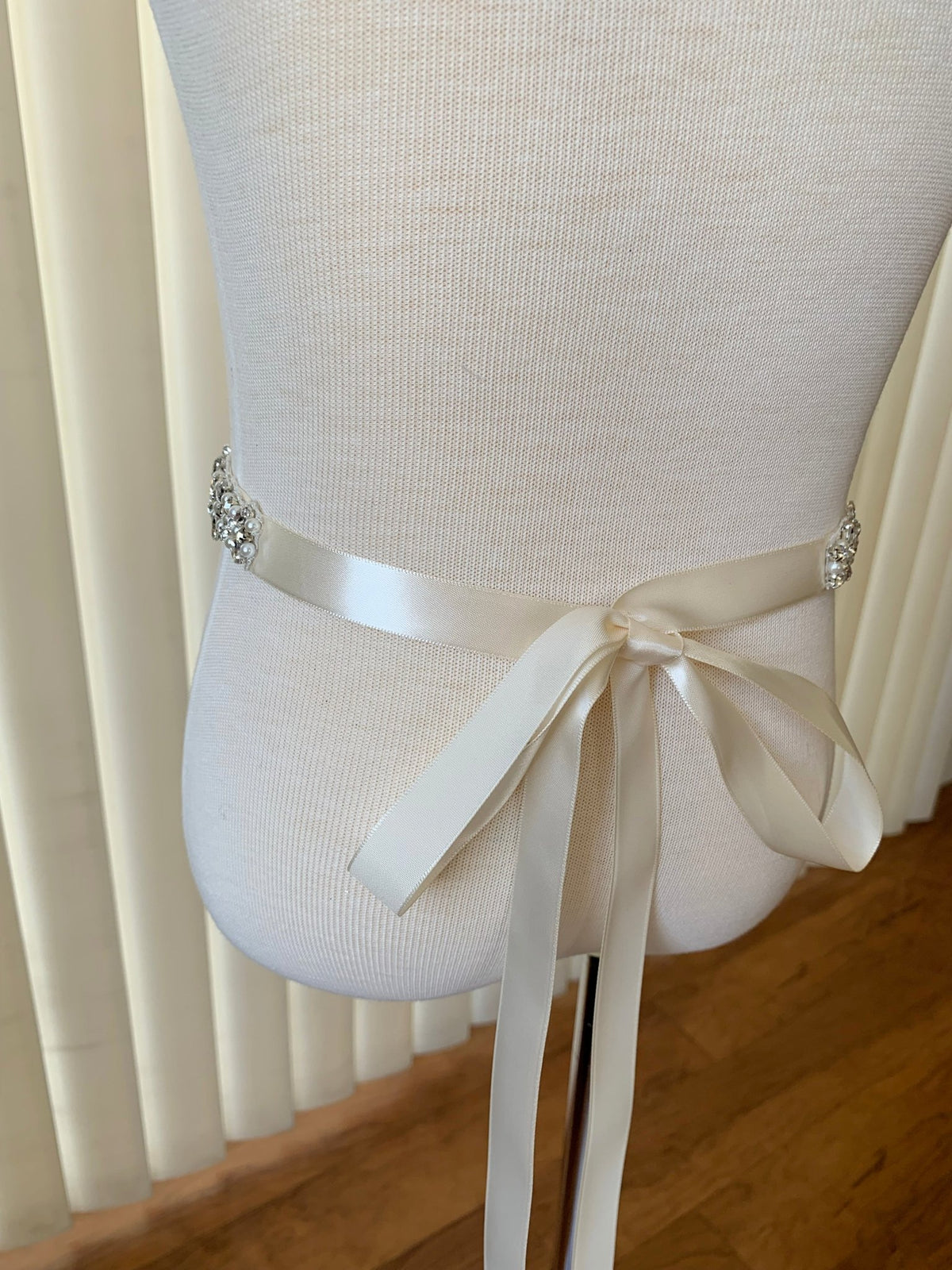 Ivory and white pearl rhinestone flower girl sash belt, back view.