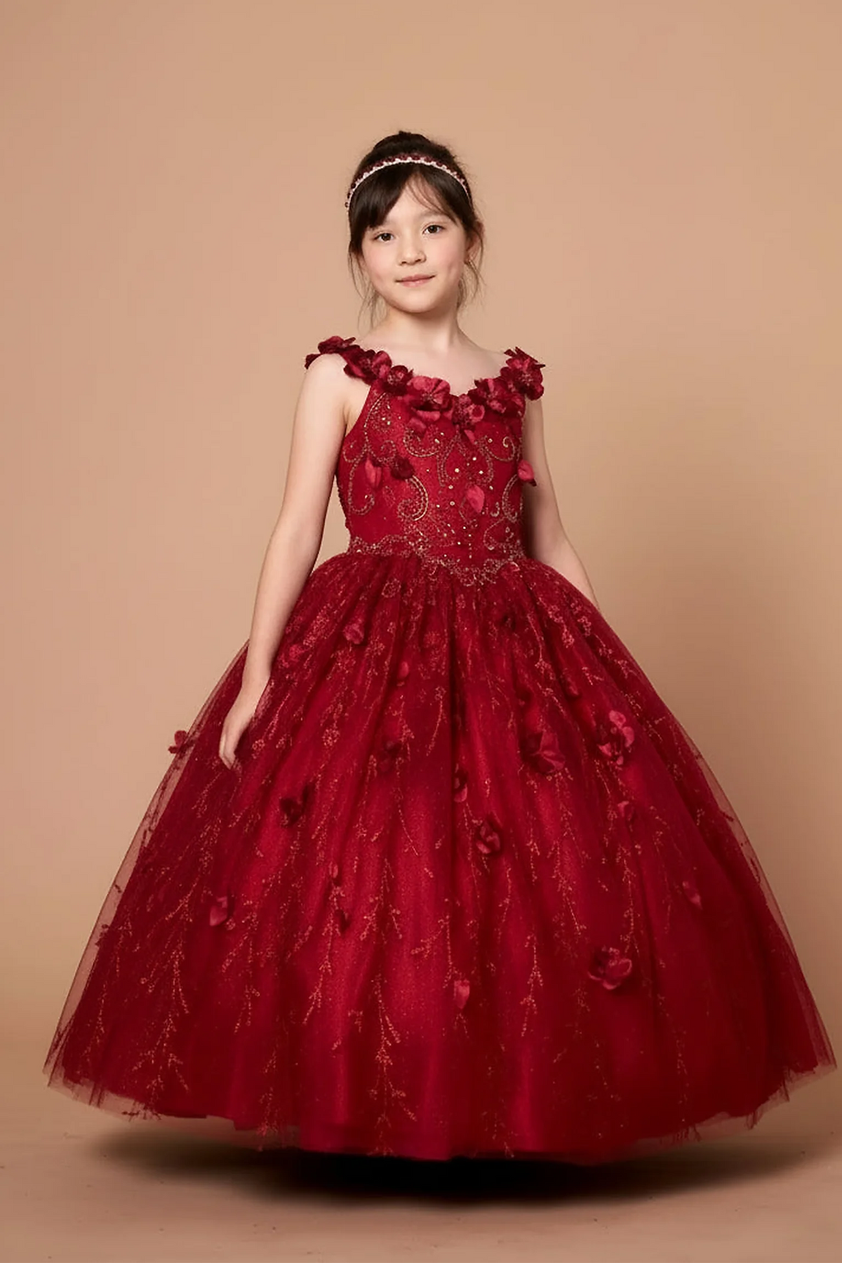 Across the silhouette, the Burgundy mini quince dress showcases off-the-shoulder bodice with dimensional flower trim and removable cape over a glittering tulle skirt.