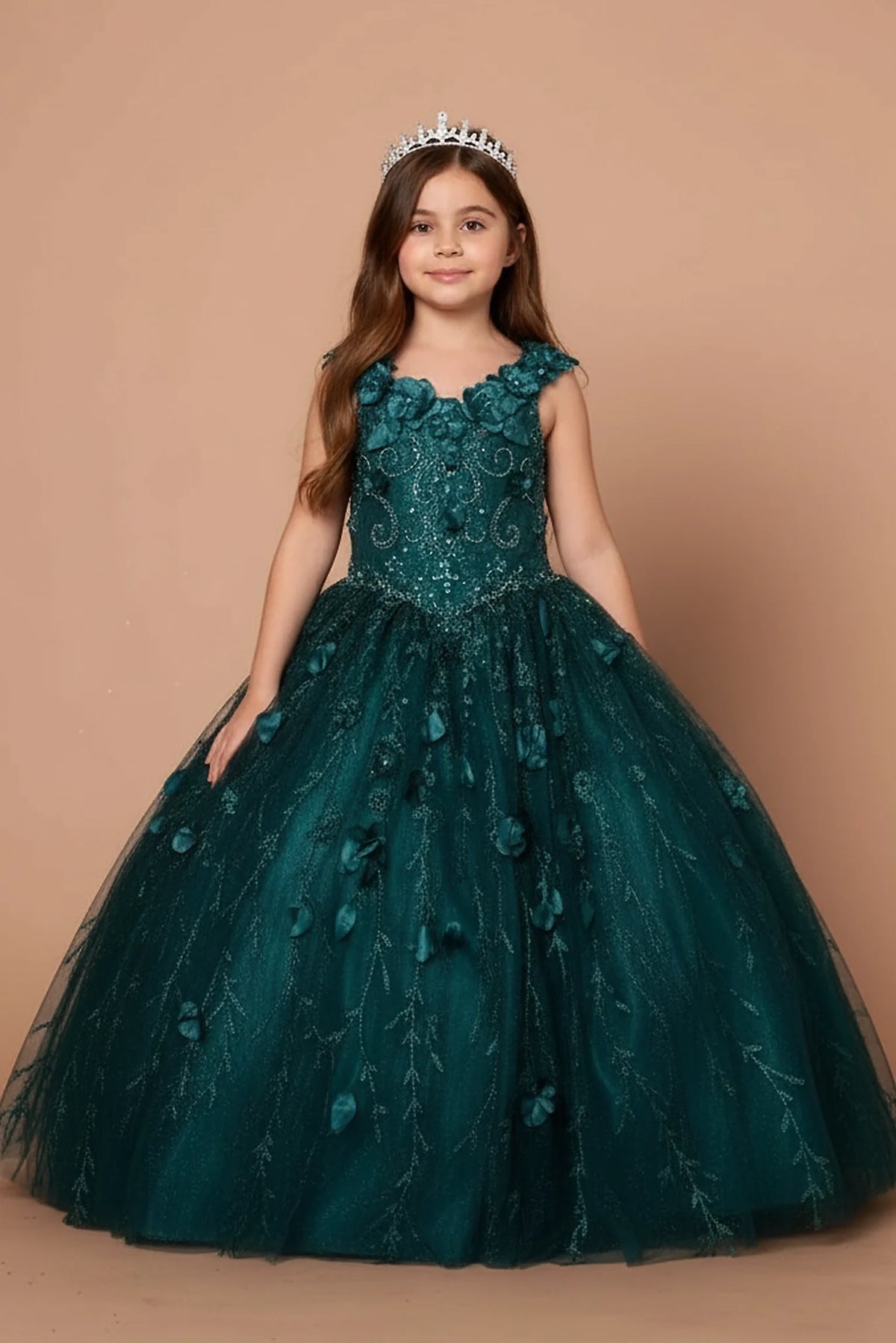 A graceful front view, the Emerald Green mini quince dress showcases off-the-shoulder bodice with dimensional flower trim and removable cape over a glittering tulle skirt.