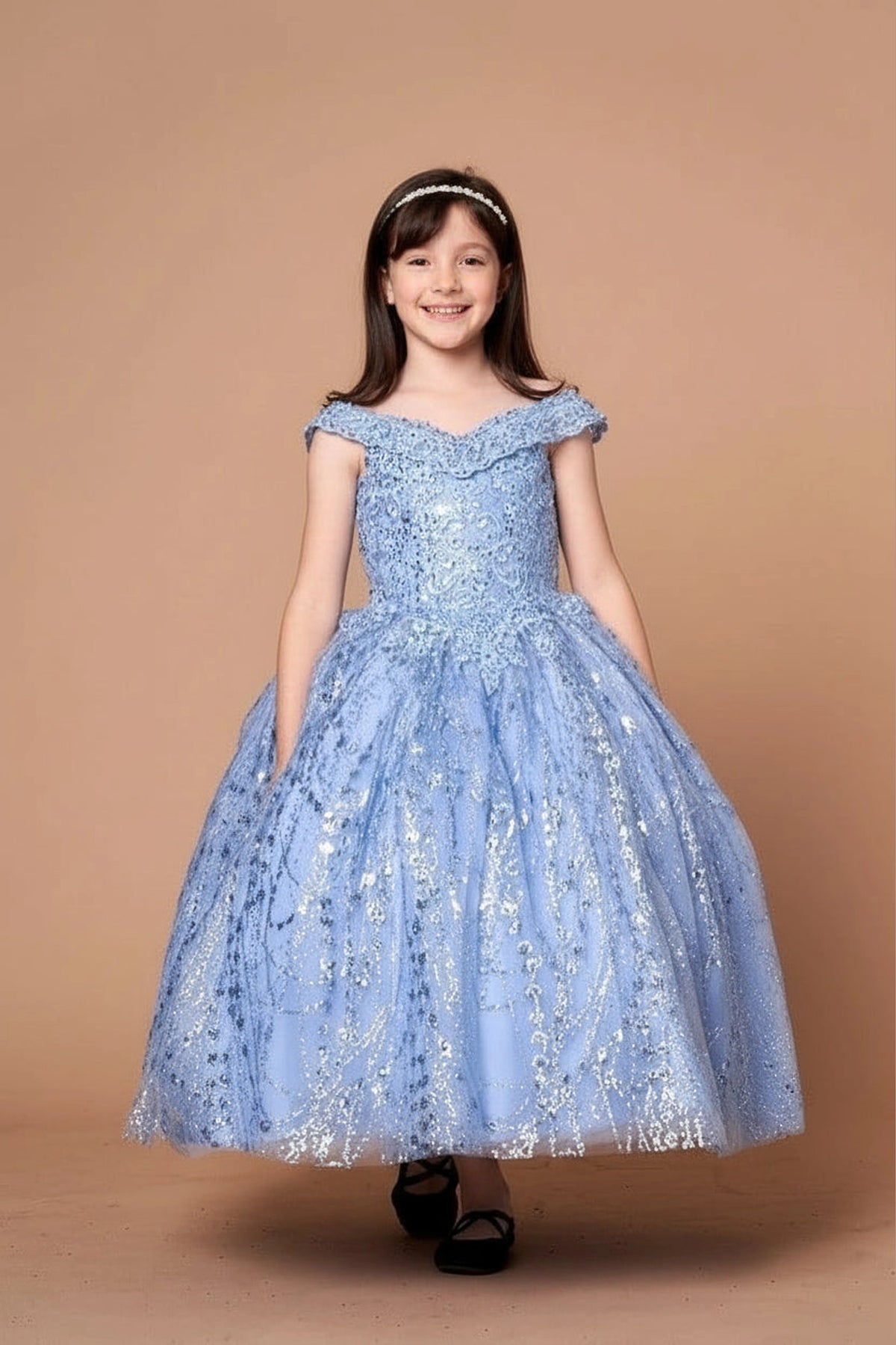 Across the silhouette, the Dusty Blue mini quince dress showcases off-the-shoulder bodice with allover sequins and glitter and matching cape over a full sparkling skirt.