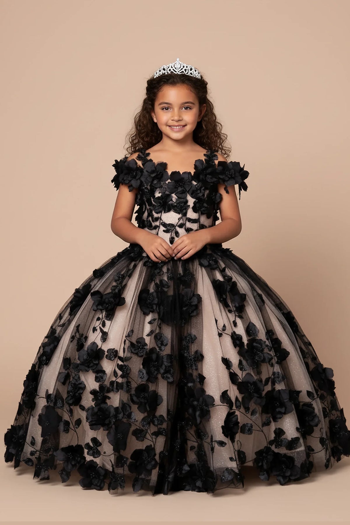 The dress profile reveals, the Black mini quince dress showcases bold floral embroidery from bodice to hem and full tulle skirt with dimensional appliqué.