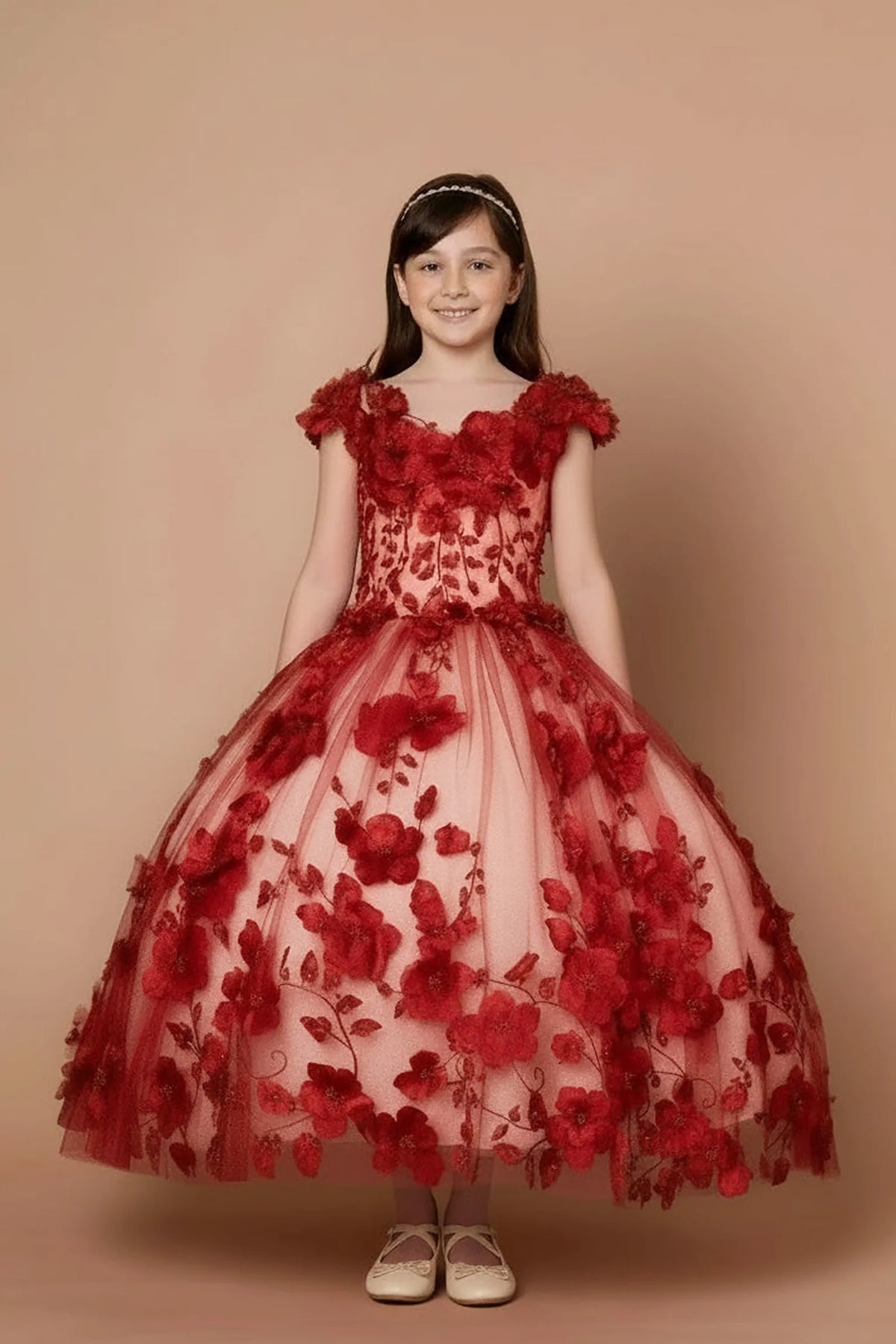 Seen at full length, the Burgundy mini quince dress showcases bold floral embroidery from bodice to hem and full tulle skirt with dimensional appliqué.