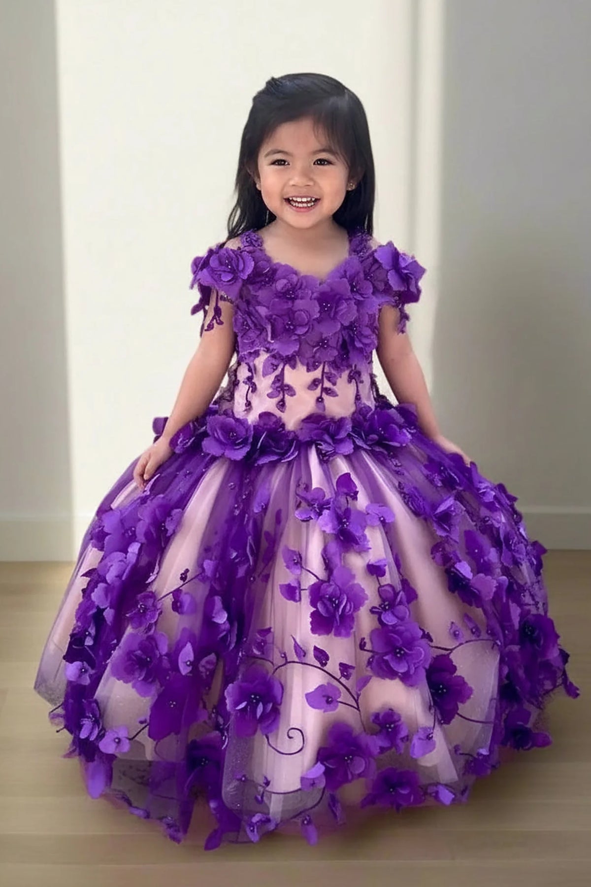 In full view, the Purple mini quince dress showcases bold floral embroidery from bodice to hem and full tulle skirt with dimensional appliqué.