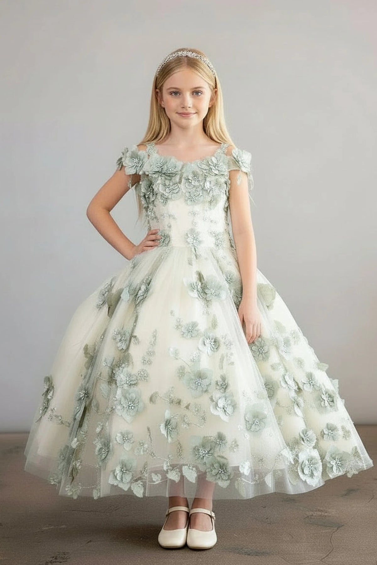 A graceful front view, the Sage mini quince dress showcases bold floral embroidery from bodice to hem and full tulle skirt with dimensional appliqué.