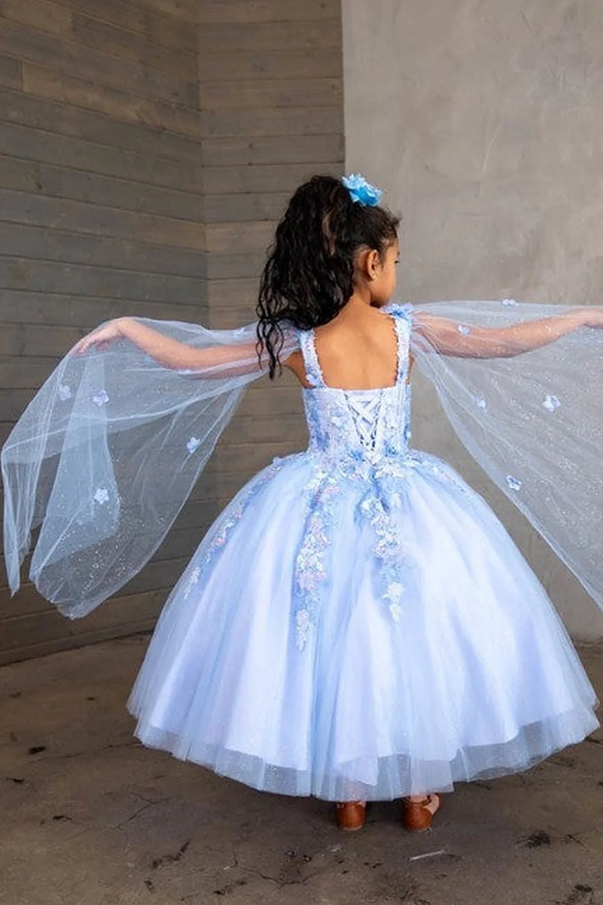 A closer crop highlights floral embroidered bodice and full tulle skirt on the Light Blue mini quince dress.
