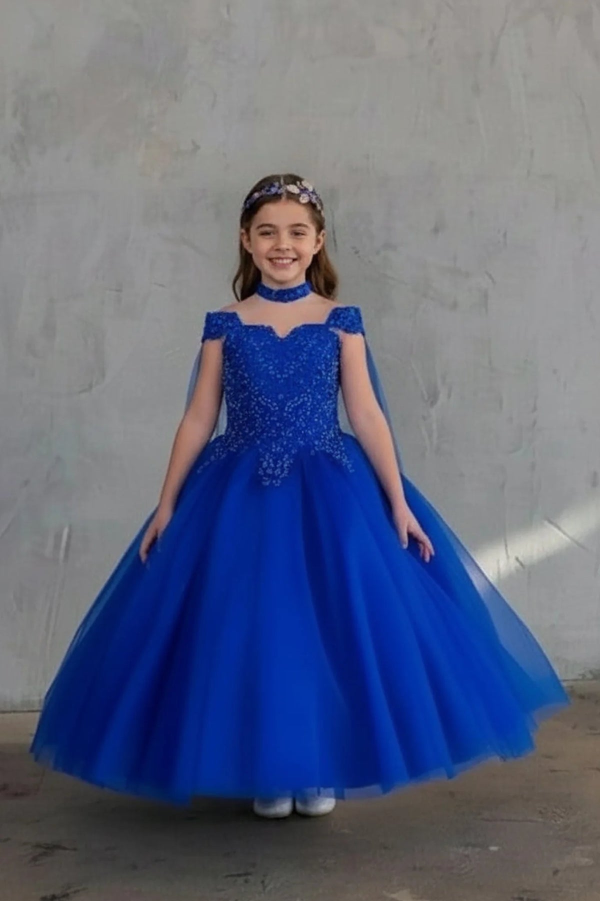 An alternate angle captures glittering embroidered tulle ball gown skirt on the Royal Blue mini quince dress.