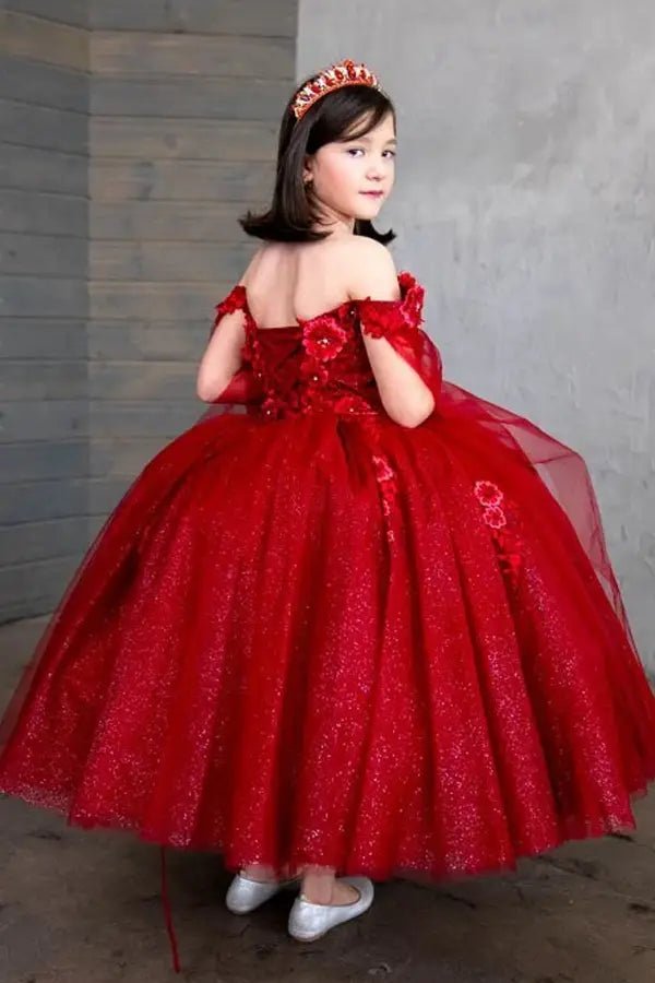 Back view of burgundy mini quince dress with lace-up closure, 3D floral detailing, removable cape sleeves, and cascading skirt.