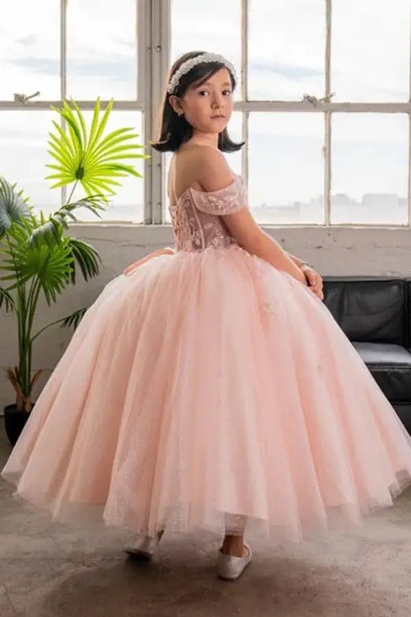 Back view of blush pink mini quince dress with lace-up closure, 3D butterfly bodice accents, and cascading layered skirt.