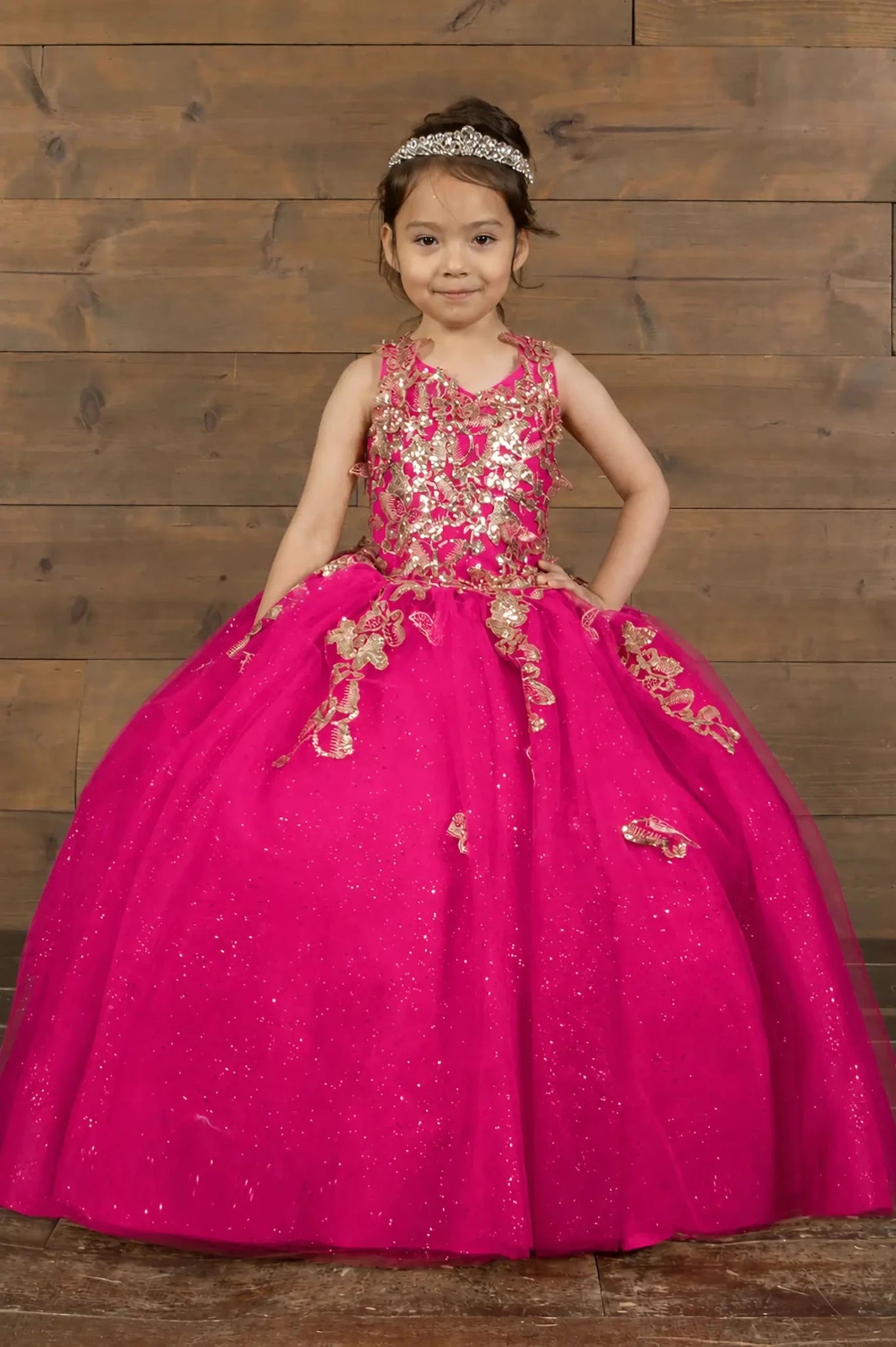 Front view of stunning fuchsia mini quince dress with 3D floral appliqué bodice and glitter tulle layered skirt.