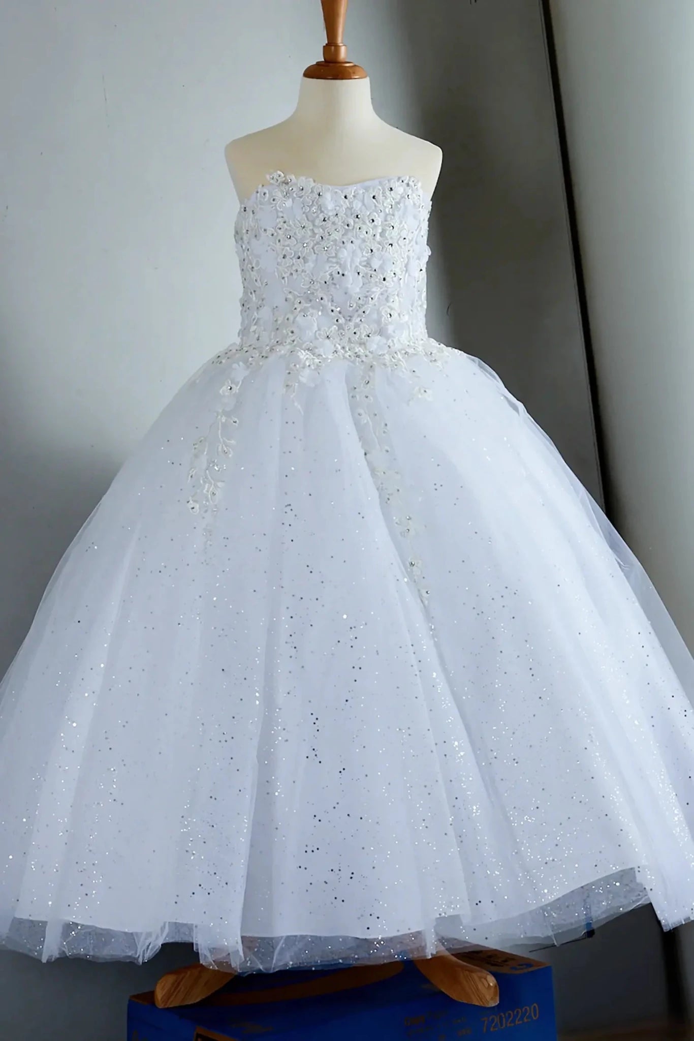 Ffront-facing in stunning blush pink mini quince dress with 3D flower appliqué bodice and glitter tulle layered skirt.