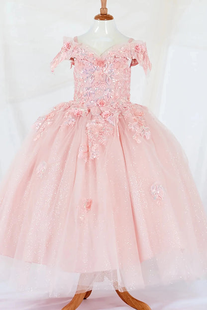 Bodice close-up highlights an blush mini quince dress featuring a fitted bodice, detachable bow accent, a glitter tulle layered skirt.