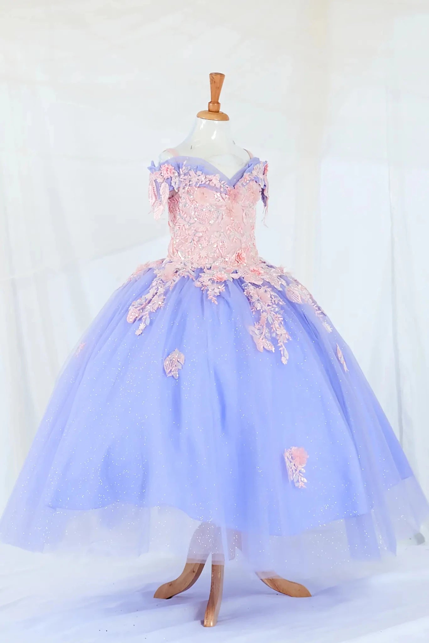 Front view of glamorous Bahama blue mini quince dress with glitter embroidery bodice, beaded sleeves, and voluminous layered skirt.