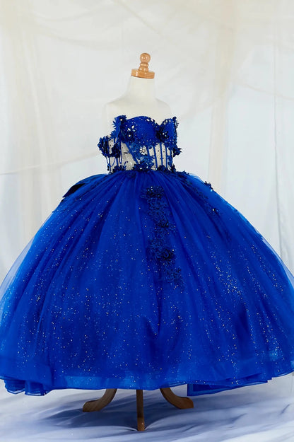 Detailed view highlights side-facing display of an royal blue mini quince dress featuring a crystal-beaded bodice.