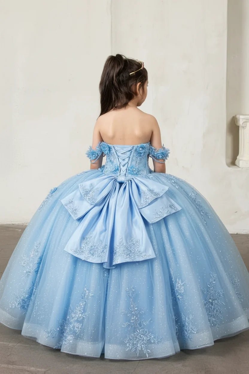 Back view of fuchsia mini quince dress with lace-up closure, detachable bow accent, crystal beading, and cascading glitter tulle skirt.