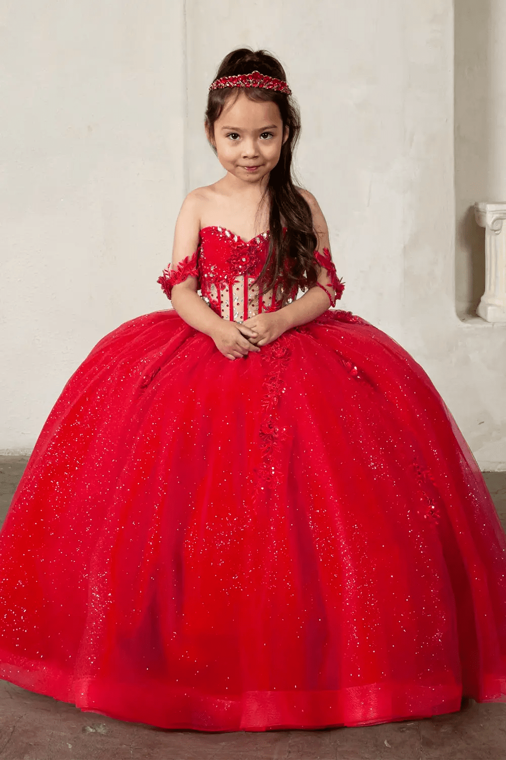 Front view of elegant red mini quince dress with crystal beaded bodice, detachable bow accent, and glitter tulle layered skirt.