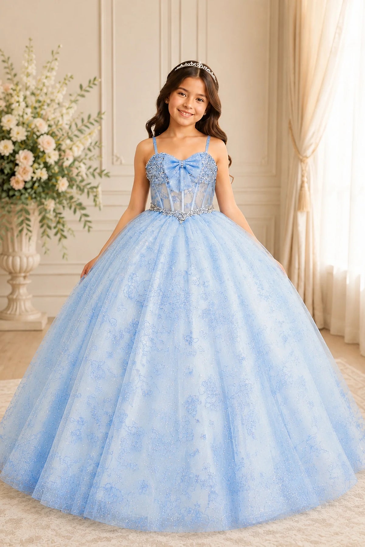 Seen at full length, the Bahama Blue mini quince dress showcases romantic off-the-shoulder lace appliqué bodice and a-line glitter tulle overlay with a lace-up back.