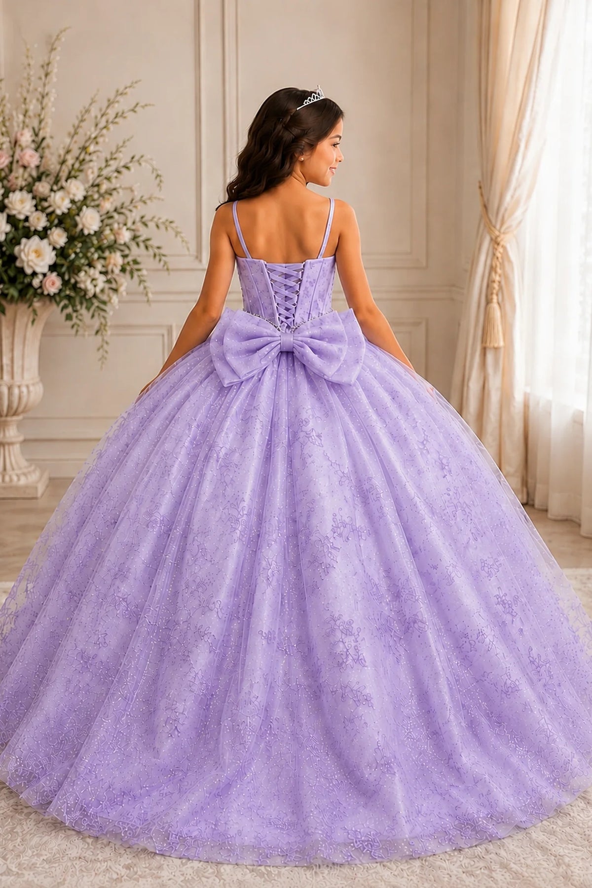 Behind the full skirt, the Lilac mini quince dress displays its lace-up finish and a-line glitter tulle overlay with a lace-up back.
