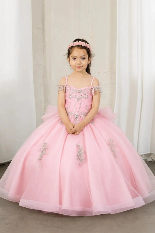 A young girl wearing a pink off-the-shoulder ball gown with silver sequin embroidery