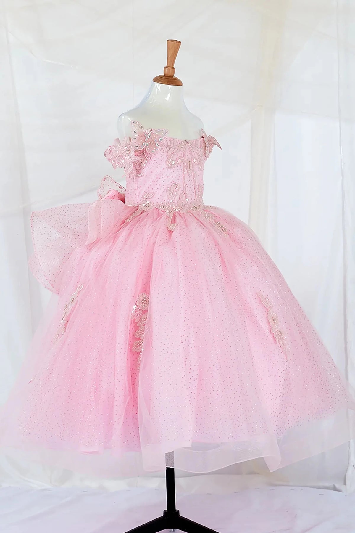 Front view of elegant pink mini quince dress with beaded corset bodice and layered glitter tulle skirt and butterfly appliques.