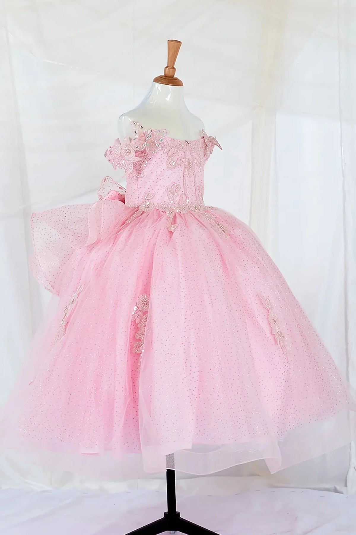 Front view of elegant pink mini quince dress with beaded corset bodice and layered glitter tulle skirt and butterfly appliques.