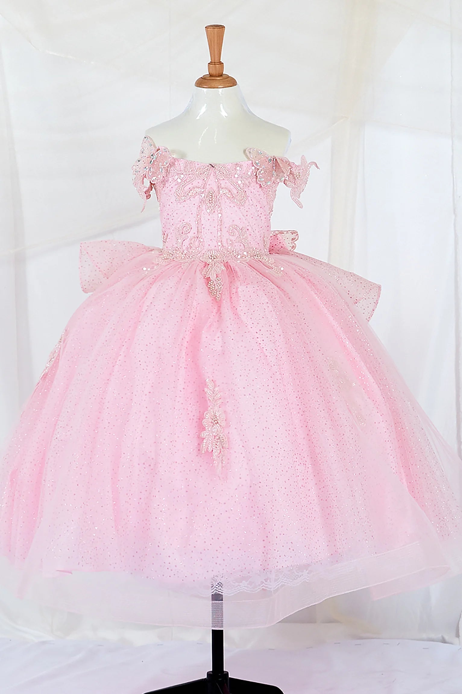 Kid standing front-facing in elegant pink ball gown with beaded corset bodice and layered glitter tulle skirt