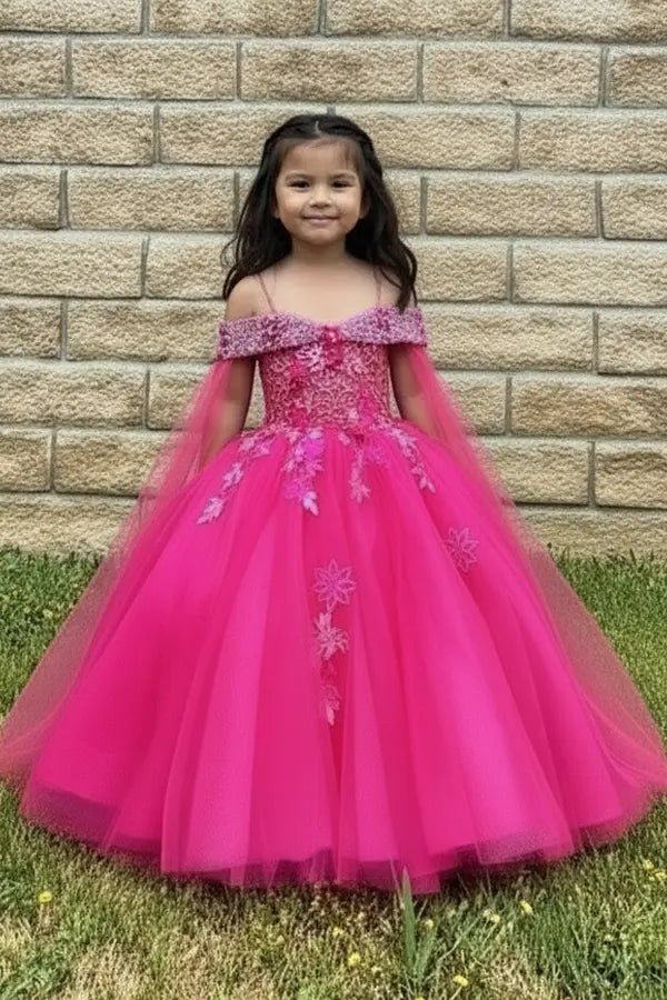 Kid standing front-facing in stunning hot pink ball gown with sheer bodice, matching cape, and voluminous layered skirt