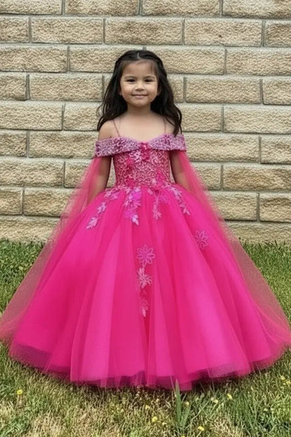 Kid standing front-facing in stunning hot pink ball gown with sheer bodice, matching cape, and voluminous layered skirt
