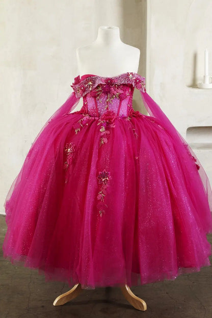 hot pink ball gown with ornate sheer bodice, matching cape, and layered skirt draped elegantly