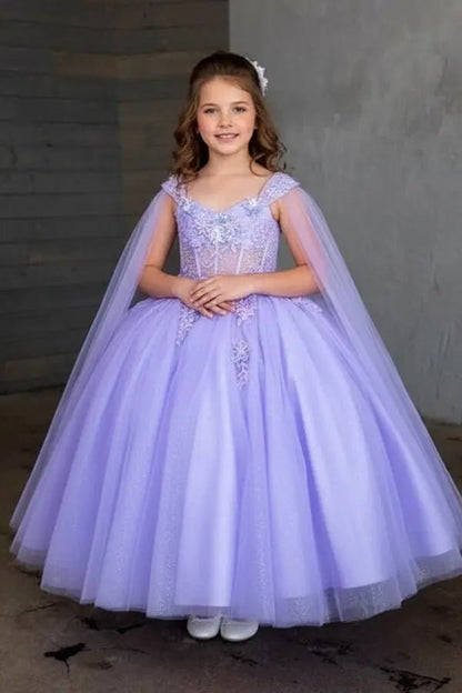 Kid standing front-facing in stunning lilac ball gown with sheer bodice, matching cape, and voluminous layered tulle skirt