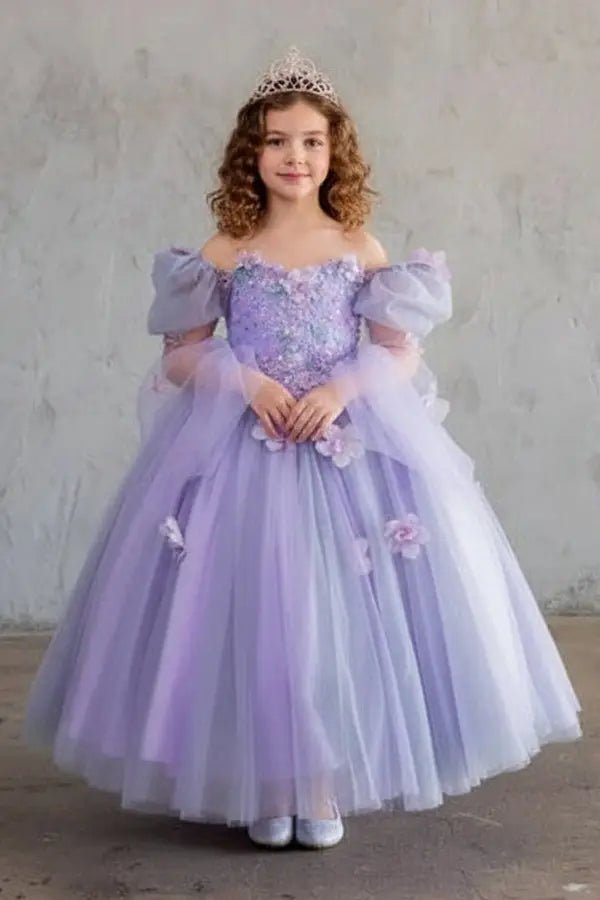 Kid standing front-facing in elegant lilac ball gown with 3D flower design, removable sleeves, and voluminous skirt