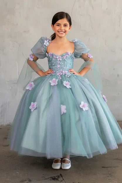 Kid standing front-facing in elegant sage ball gown with 3D flower design, removable sleeves, and voluminous skirt