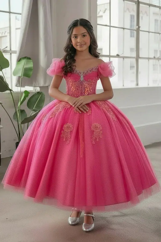 Young woman standing front-facing in elegant hot pink ball gown with illusion sweetheart corset bodice and voluminous layered skirt

