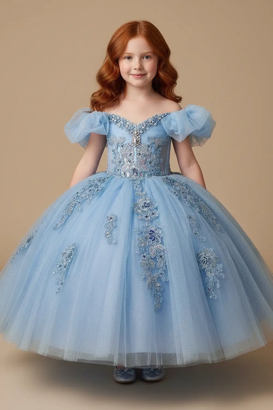 Young woman standing front-facing in elegant light blue ball gown with illusion sweetheart corset bodice and voluminous layered skirt

