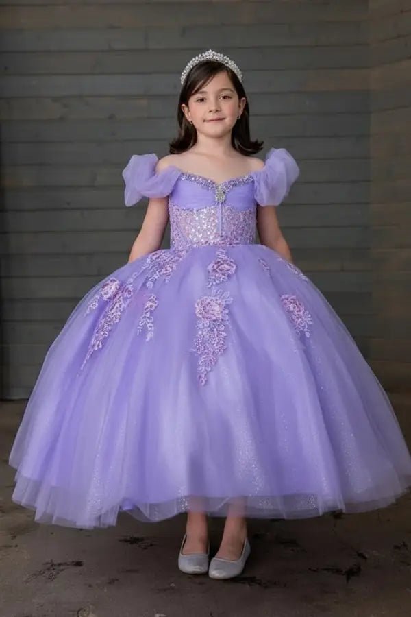 Kid standing front-facing in elegant lilac ball gown with illusion sweetheart bodice and voluminous flowing skirt