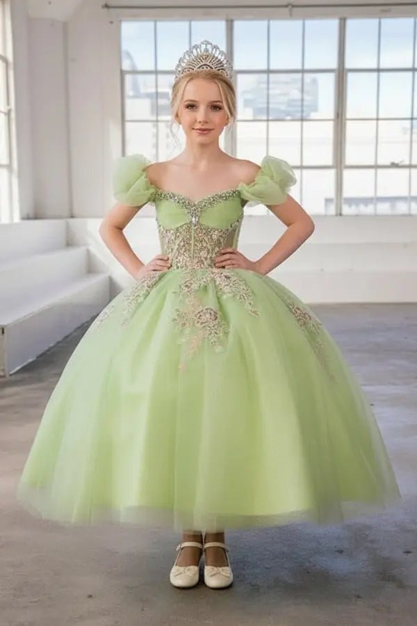 Kid standing front-facing in elegant lime ball gown with illusion sweetheart bodice and voluminous full skirt