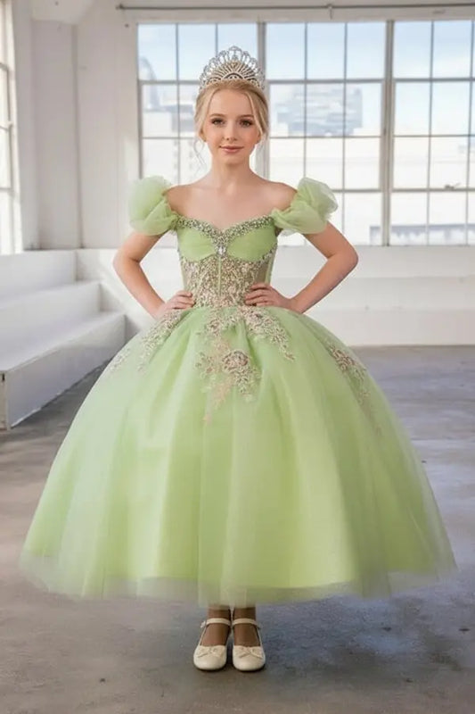 Young woman standing front-facing in elegant lime ball gown with illusion sweetheart bodice and voluminous full skirt
