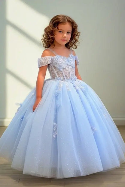Kid standing front-facing in stunning light blue ball gown with 3D butterfly bodice and voluminous layered skirt