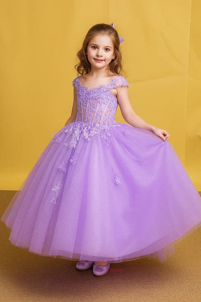 Kid standing front-facing in elegant champagne ball gown with embroidered layered bodice and voluminous full skirt