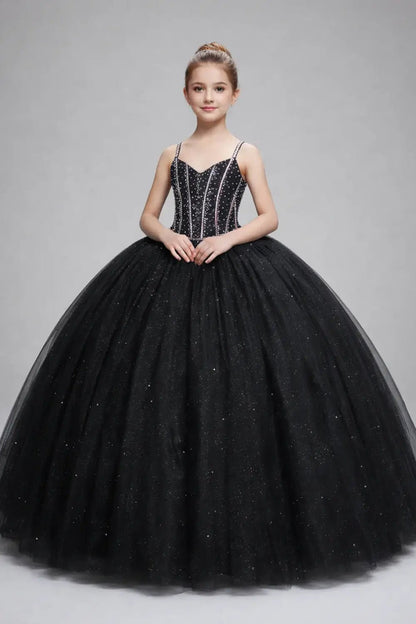 Kid standing front-facing in stunning black ball gown with 3D floral appliqué bodice, glitter tulle accents, and voluminous layered skirt