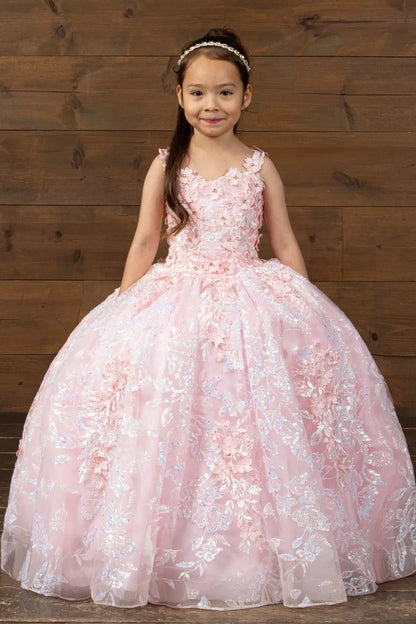 Kid standing front-facing in blush and gold ball gown with 3D flower appliqué bodice, butterfly accents, and glitter tulle layered skirt