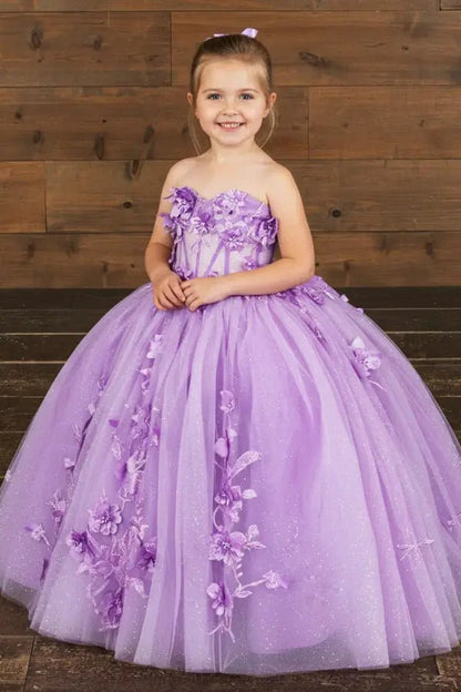 Kid standing front-facing in enchanting lilac ball gown with 3D floral appliqué bodice and glitter tulle layered skirt