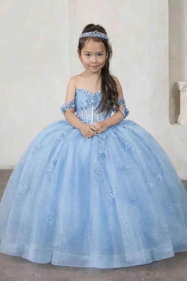 Kid standing front-facing in elegant light blue ball gown with crystal beaded bodice, detachable bow accent, and glitter tulle layered skirt