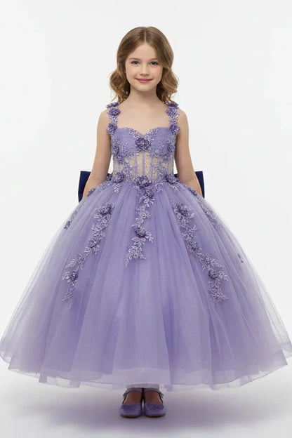 Kid standing front-facing in stunning emerald ball gown with 3D floral appliqué bodice and glitter tulle layered skirt