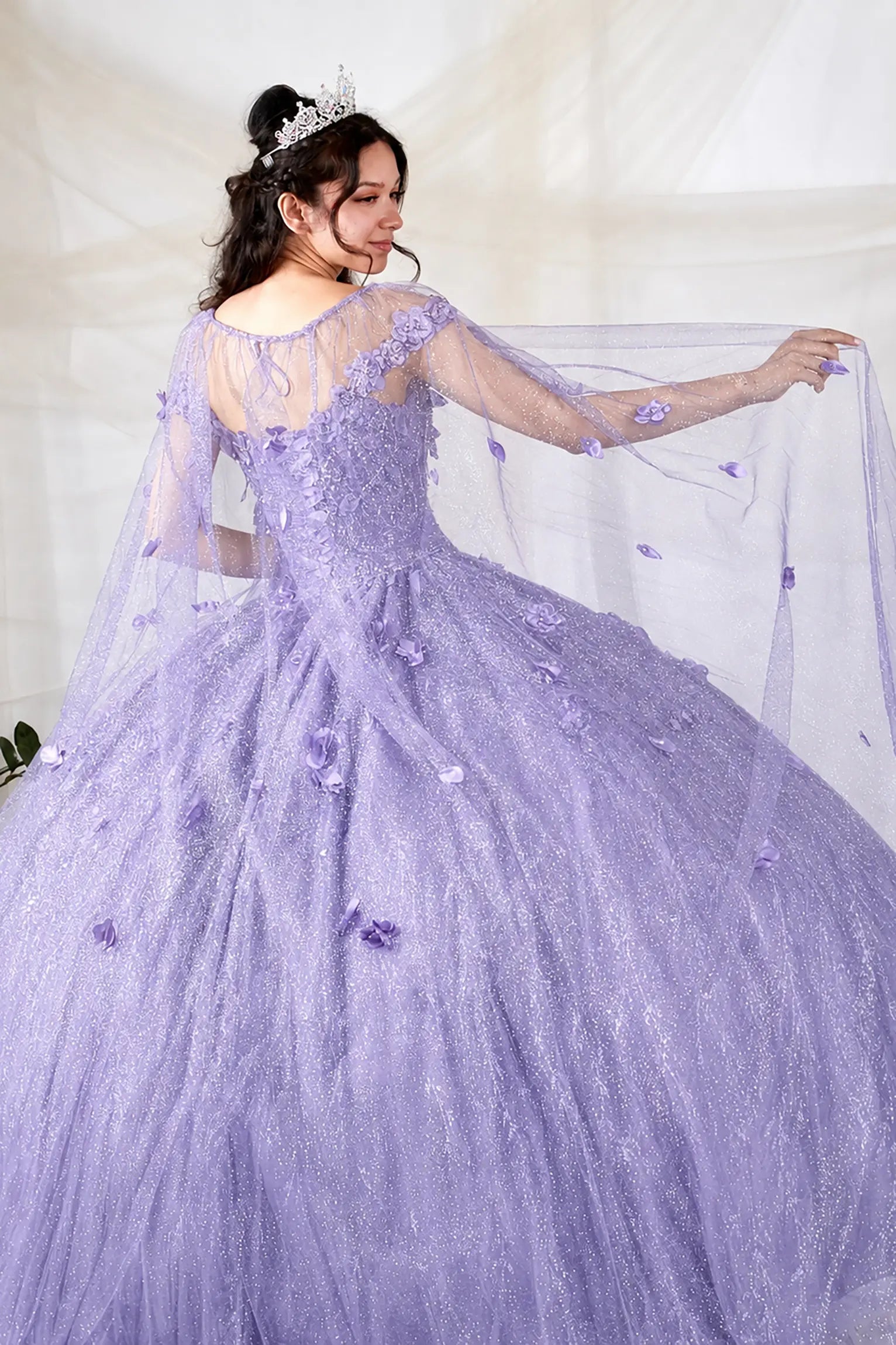 Back view of lilac quinceanera dress showing detachable sheer cape with 3D floral appliques