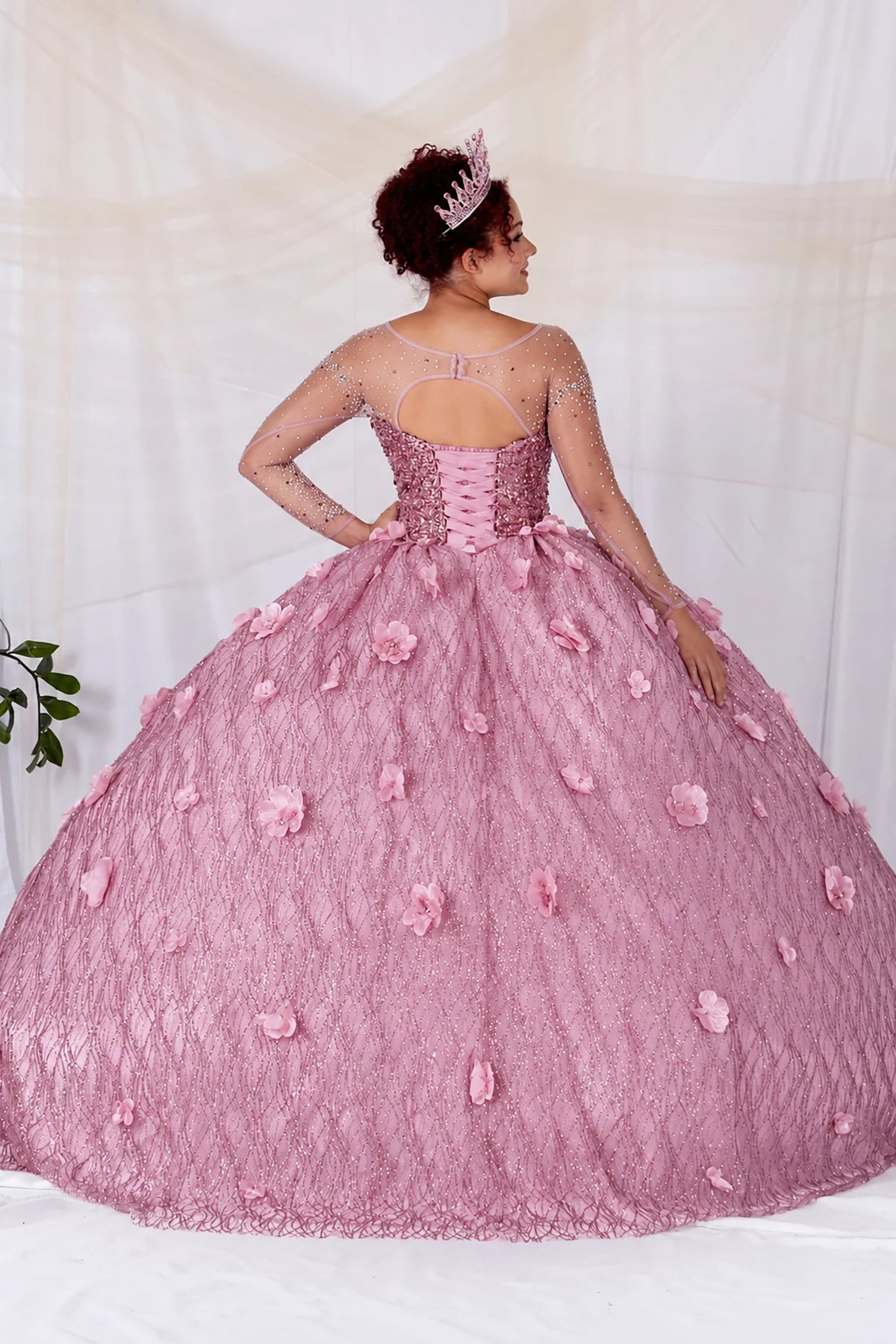 From behind, the Dusty Rose quinceañera ball gown reveals a shaped lace-up back and the sweep of the full skirt.