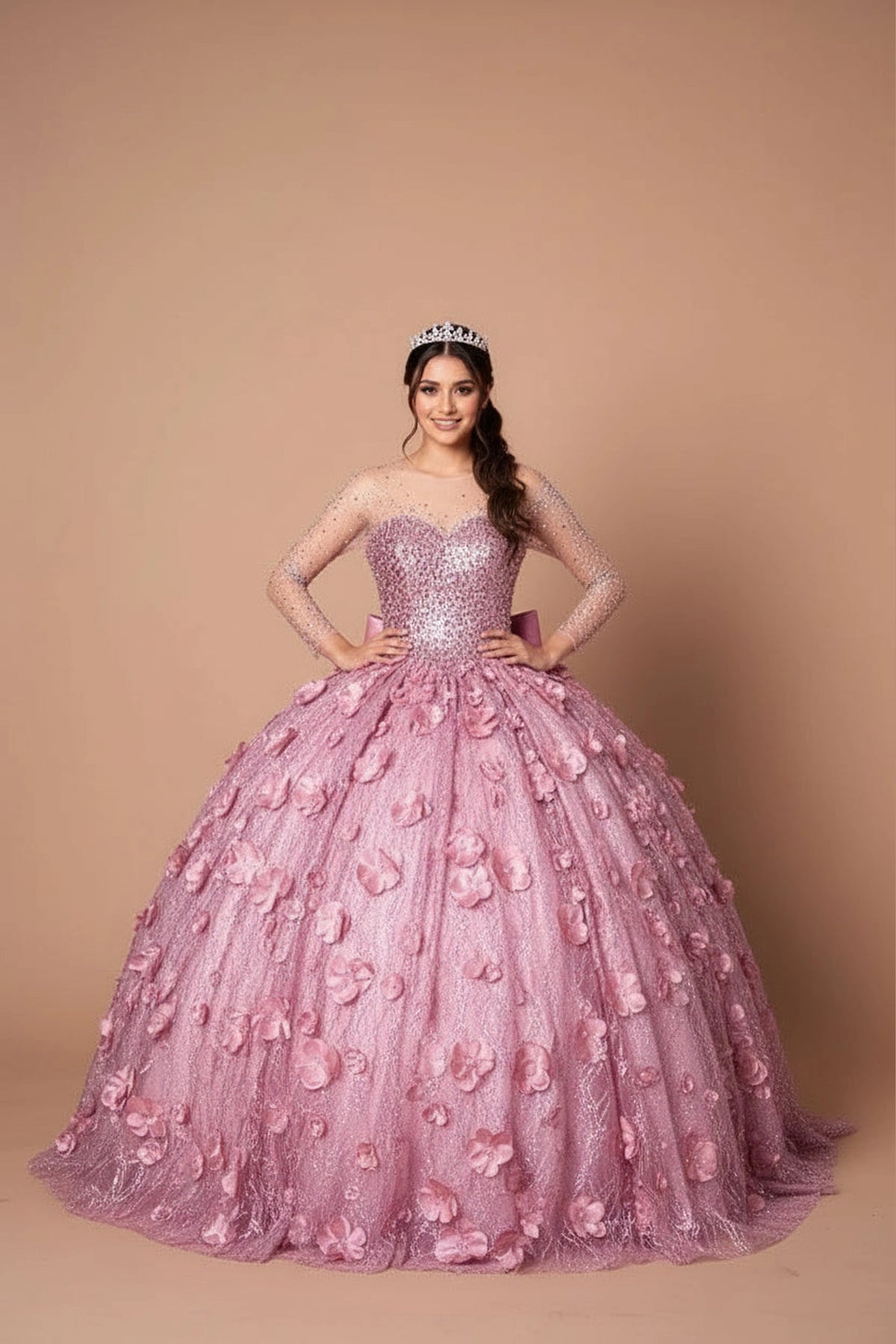 Dimensional flowers across the textured skirt defines the Dusty Rose quinceañera dress in this detailed view.