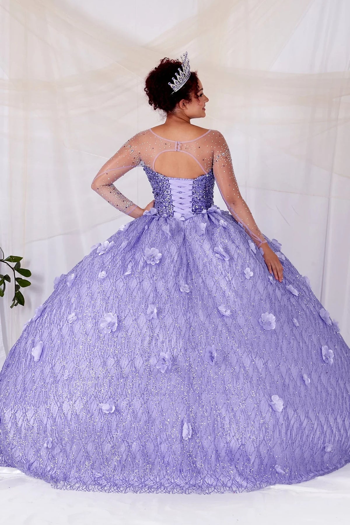 From behind, the Lilac quinceañera ball gown reveals a shaped lace-up back and the sweep of the full skirt.