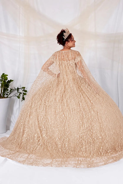 Woman in a champagne quinceanera dress with gold sequin and detachable cape