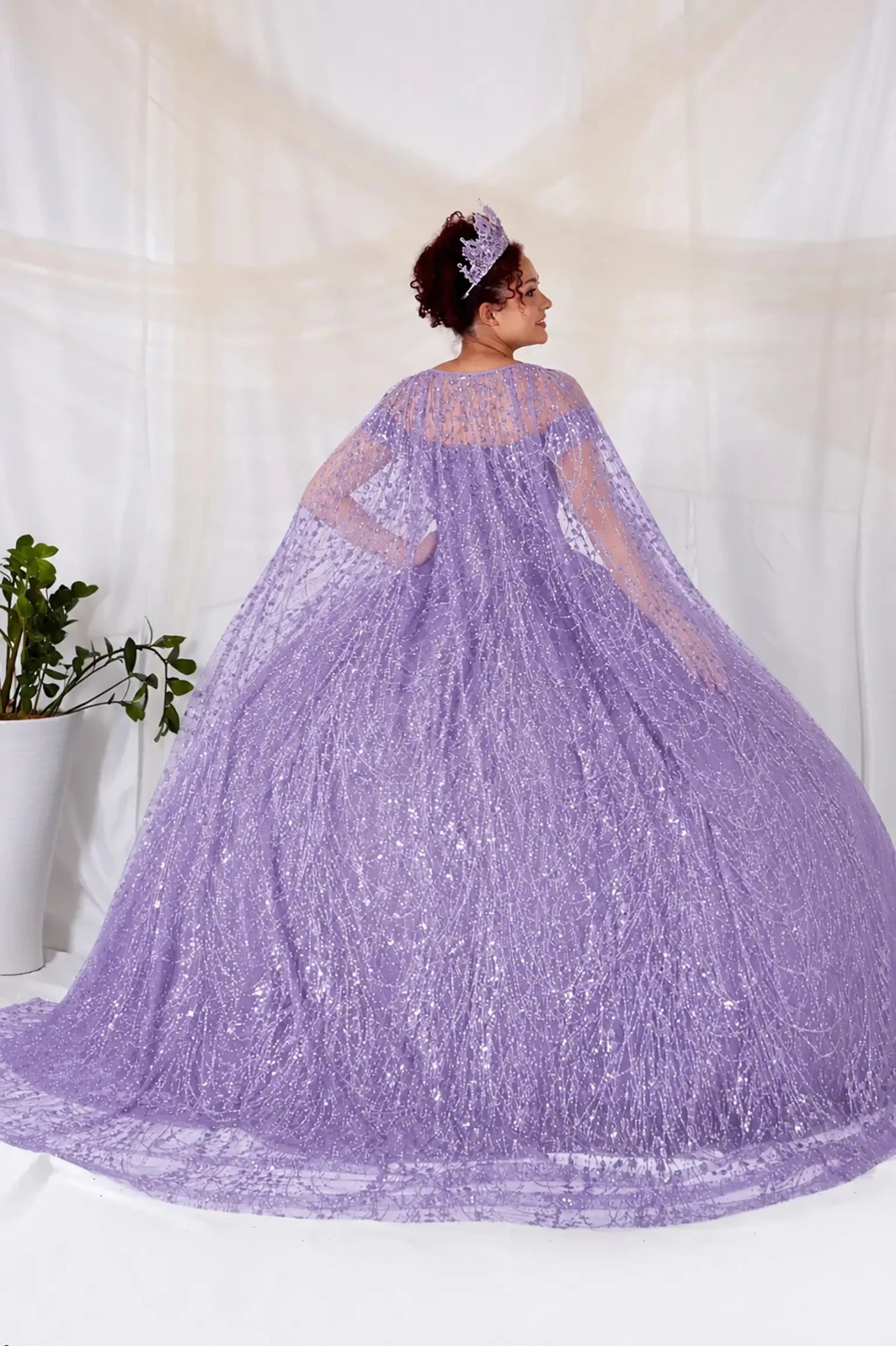 woman wearing Lilac sequin quinceanera ball gown with and matching  cape